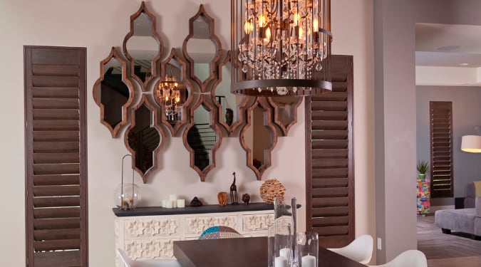 Sometimes there's nothing that can match the style of a real wood shutter. Ovation shutters in a dining room